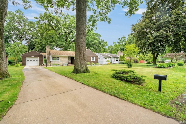 241 Sylvan Glen Dr, South Bend, IN 46615 - single story home featuring concrete driveway, a chimney, a front yard, and an outbuilding