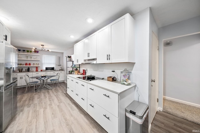 241 Sylvan Glen Dr, South Bend, IN 46615 - kitchen with stainless steel fridge, white cabinets, light wood finished floors, black electric stovetop, and light countertops