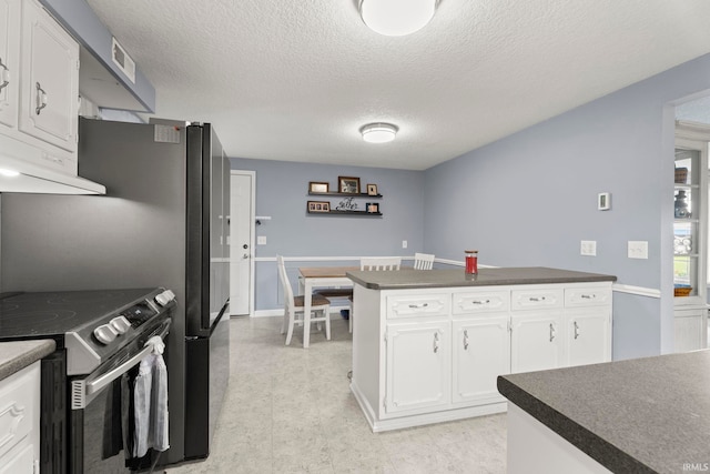17135 Old 24 Rd, Woodburn, IN 46797 - kitchen featuring stainless steel electric range oven, under cabinet range hood, dark countertops, white cabinetry, and a textured ceiling