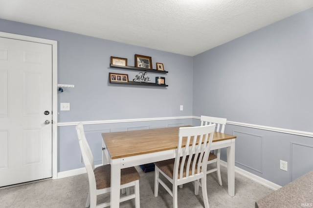 17135 Old 24 Rd, Woodburn, IN 46797 - dining area with a wainscoted wall, a textured ceiling, and a decorative wall
