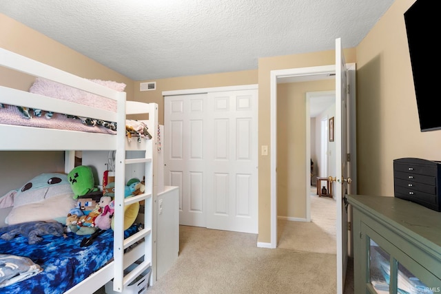 17135 Old 24 Rd, Woodburn, IN 46797 - bedroom featuring light carpet, a textured ceiling, and a closet