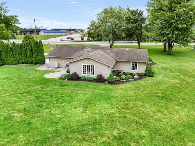 17135 Old 24 Rd, Woodburn, IN 46797 - back of house featuring a yard and roof with shingles