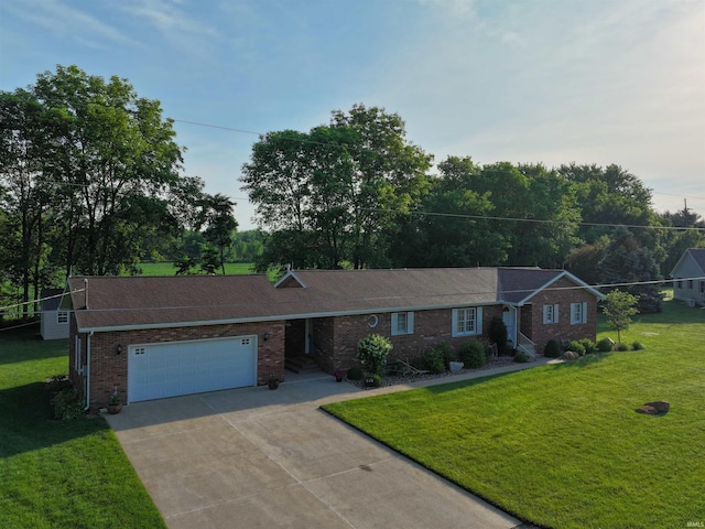 830 E Oak View Est, Winamac, IN 46996 - ranch-style house featuring an attached garage, concrete driveway, a front lawn, and brick siding