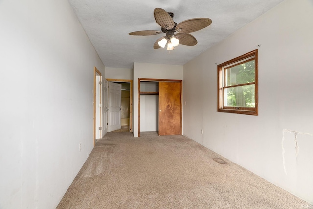 4508 Wells St, Delphi, IN 46923 - unfurnished bedroom featuring light carpet, multiple closets, and a ceiling fan