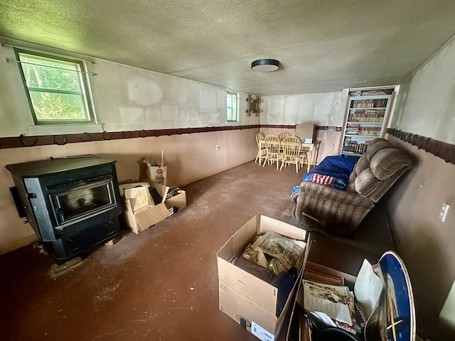 1995 S 445 E, Royer Lake, Lagrange, IN 46761 - living area featuring a wood stove, a textured ceiling, and concrete floors