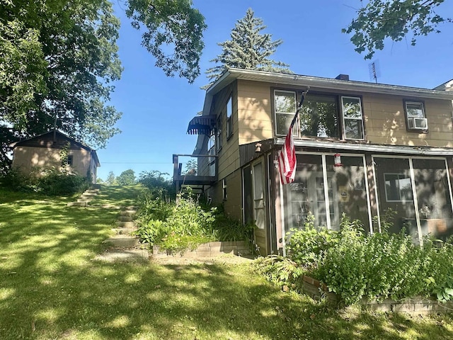 1995 S 445 E, Royer Lake, Lagrange, IN 46761 - view of side of property featuring a sunroom and a lawn