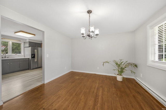1545 Werling Rd, New Haven, IN 46774 - spare room with a chandelier, a baseboard radiator, and wood finished floors