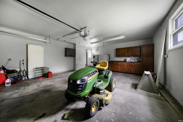 1545 Werling Rd, New Haven, IN 46774 - garage featuring a garage door opener and refrigerator