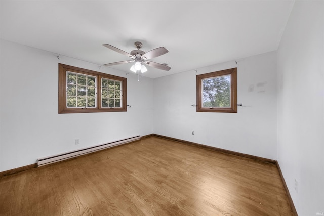 1545 Werling Rd, New Haven, IN 46774 - unfurnished room with a baseboard radiator, a ceiling fan, healthy amount of natural light, and wood finished floors