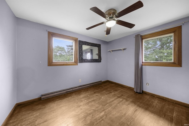 1545 Werling Rd, New Haven, IN 46774 - spare room featuring a baseboard radiator, healthy amount of natural light, wood finished floors, and a ceiling fan