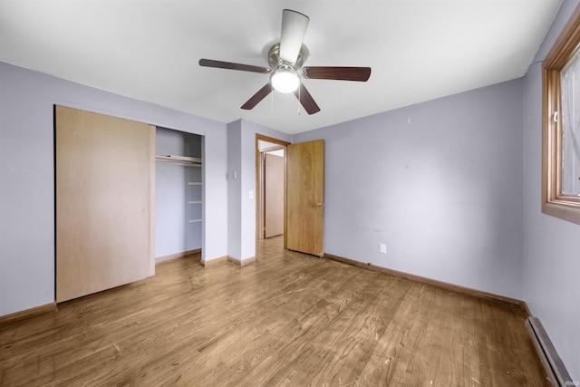1545 Werling Rd, New Haven, IN 46774 - unfurnished bedroom with wood finished floors, a closet, a ceiling fan, and a baseboard radiator