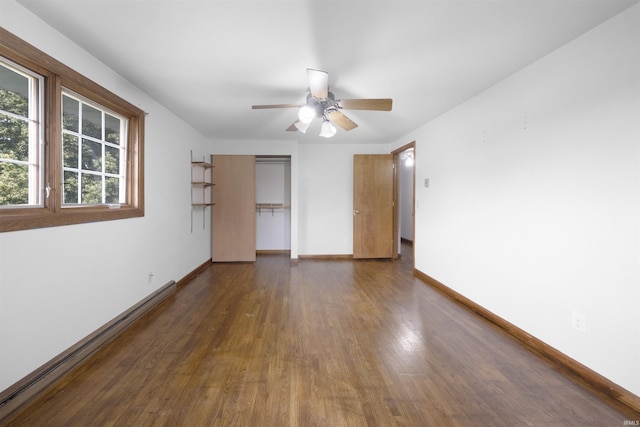 1545 Werling Rd, New Haven, IN 46774 - unfurnished bedroom featuring baseboard heating, dark wood-style flooring, ceiling fan, and a closet
