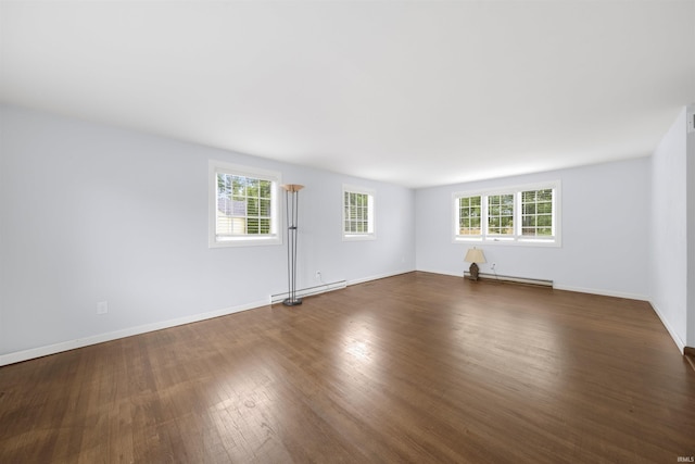 1545 Werling Rd, New Haven, IN 46774 - empty room with dark wood finished floors and a baseboard heating unit