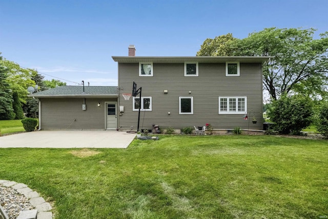 1545 Werling Rd, New Haven, IN 46774 - back of property featuring a chimney, a patio, and a lawn