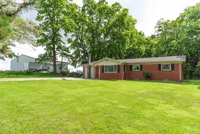 3557 N 150 E, Camden, IN 46917 - ranch-style house with an attached garage, brick siding, a front yard, driveway, and a chimney