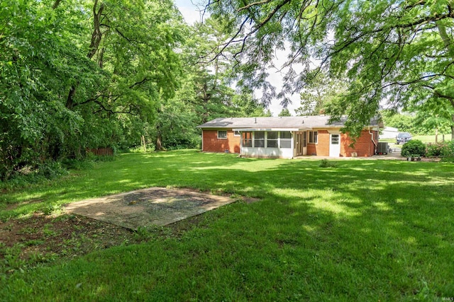 3557 N 150 E, Camden, IN 46917 - back of property with brick siding, a sunroom, and a lawn
