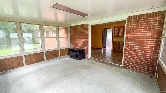 3557 N 150 E, Camden, IN 46917 - unfurnished sunroom featuring carpet floors, brick wall, and wooden walls