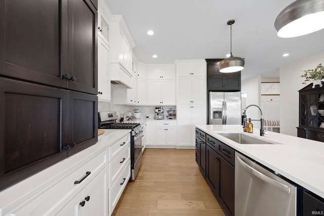 4685 N Triple Crown Dr, Bloomington, IN 47404 - kitchen with appliances with stainless steel finishes, light countertops, white cabinetry, light wood-style floors, and recessed lighting