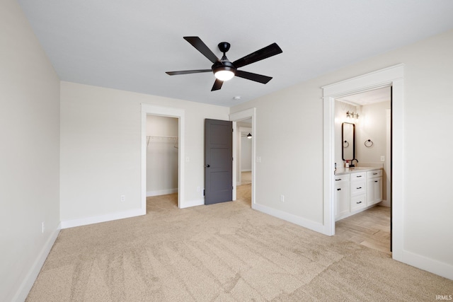 4685 N Triple Crown Dr, Bloomington, IN 47404 - unfurnished bedroom with light carpet, a walk in closet, a closet, ensuite bath, and ceiling fan