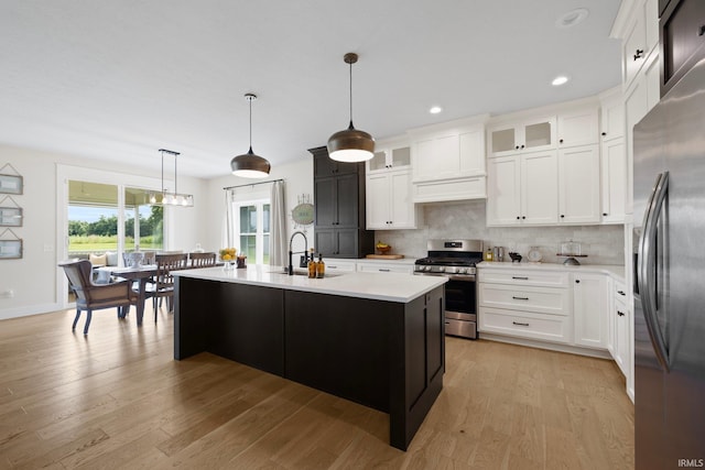 4685 N Triple Crown Dr, Bloomington, IN 47404 - kitchen featuring appliances with stainless steel finishes, light countertops, tasteful backsplash, light wood-style floors, and recessed lighting