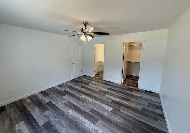 1405 Rosewood Dr, Washington, IN 47501 - unfurnished bedroom featuring dark wood-style floors, a walk in closet, a ceiling fan, and a closet