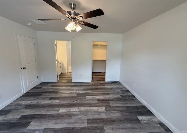 1405 Rosewood Dr, Washington, IN 47501 - unfurnished bedroom featuring dark wood-type flooring, a walk in closet, a closet, ceiling fan, and ensuite bathroom