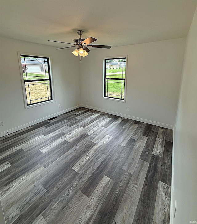 1405 Rosewood Dr, Washington, IN 47501 - empty room featuring dark wood-style floors, healthy amount of natural light, and ceiling fan