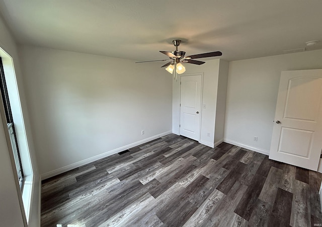 1405 Rosewood Dr, Washington, IN 47501 - unfurnished bedroom featuring dark wood-type flooring, a ceiling fan, and a closet