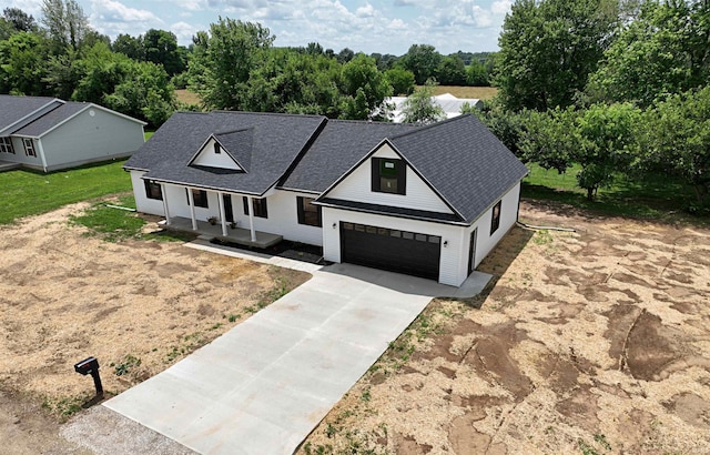 1405 Rosewood Dr, Washington, IN 47501 - modern farmhouse style home with covered porch, concrete driveway, a shingled roof, and a garage