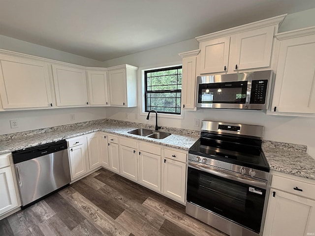 1405 Rosewood Dr, Washington, IN 47501 - kitchen with stainless steel appliances, dark wood-style flooring, white cabinets, and light stone counters