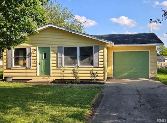 104 Fremont Ln, Decatur, IN 46733 - view of front of property featuring a garage, a front yard, and driveway