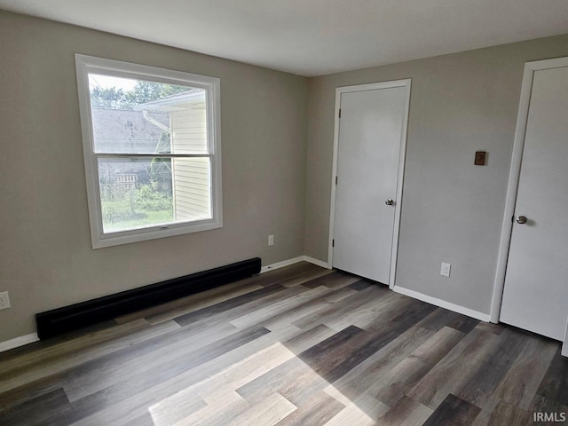 104 Fremont Ln, Decatur, IN 46733 - unfurnished bedroom with a baseboard radiator and wood finished floors