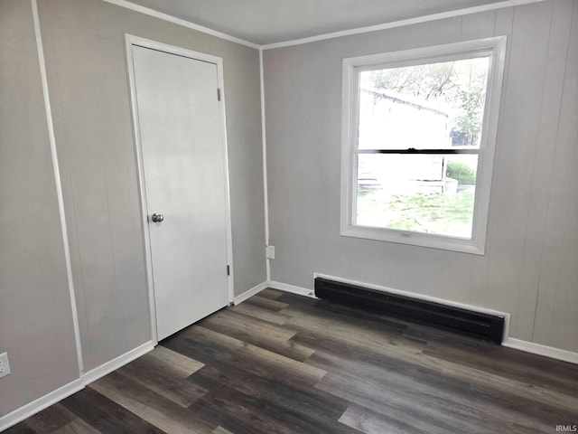104 Fremont Ln, Decatur, IN 46733 - unfurnished bedroom with a baseboard heating unit, dark wood-style flooring, multiple windows, and crown molding