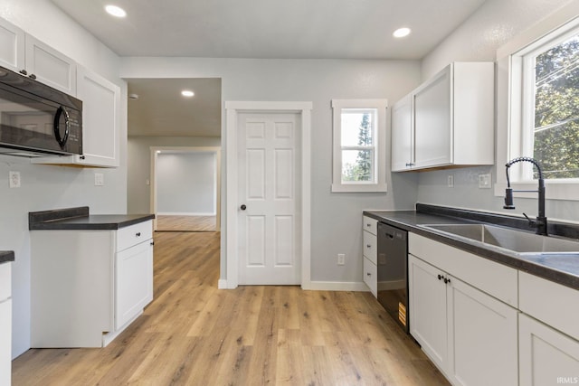 610 N 5th St, Goshen, IN 46528 - kitchen with dishwashing machine, black microwave, dark countertops, light wood-style flooring, and recessed lighting