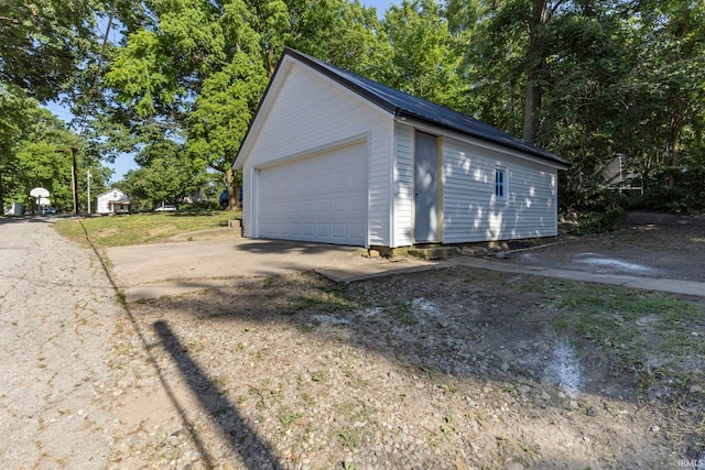 610 N 5th St, Goshen, IN 46528 - detached garage with view of wooded area