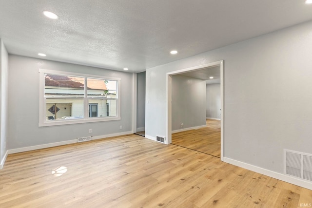 610 N 5th St, Goshen, IN 46528 - spare room featuring recessed lighting, light wood-type flooring, and a textured ceiling