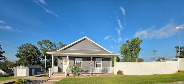 826 SE 2nd St, Washington, IN 47501 - view of front facade with a garage, covered porch, and a shed