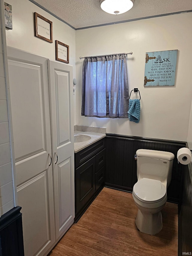 826 SE 2nd St, Washington, IN 47501 - bathroom featuring wood finished floors, a textured ceiling, and vanity