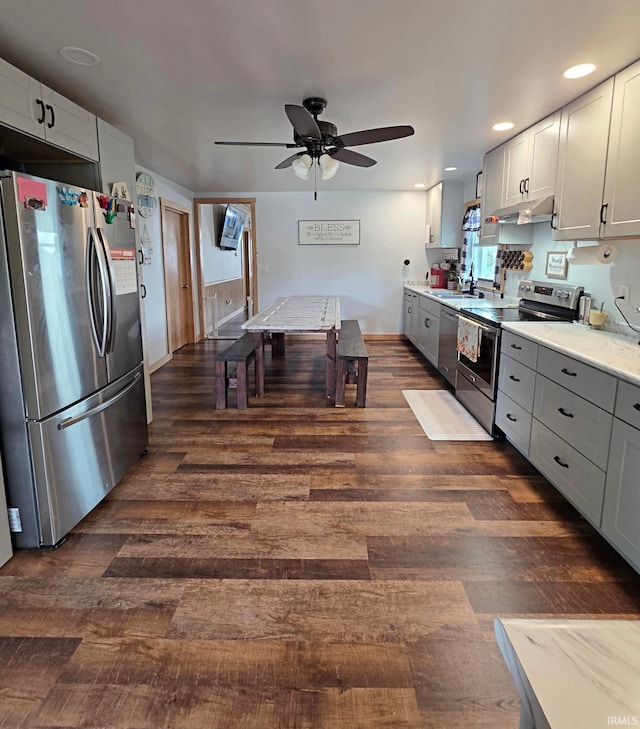 826 SE 2nd St, Washington, IN 47501 - kitchen featuring appliances with stainless steel finishes, a ceiling fan, dark wood-style flooring, recessed lighting, and light stone countertops