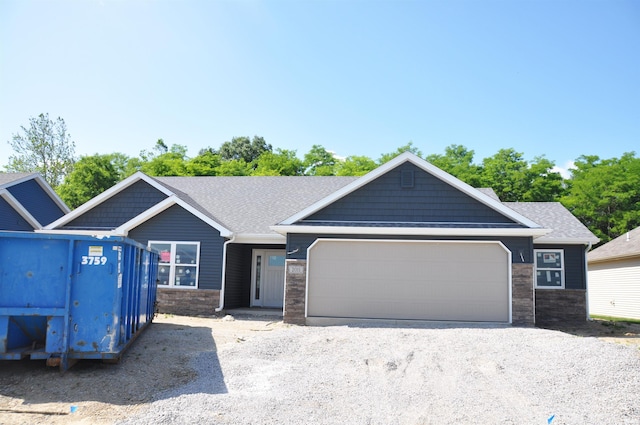 2011 Winesap Way, Kendallville, IN 46755 - view of front facade featuring a garage, stone siding, and roof with shingles