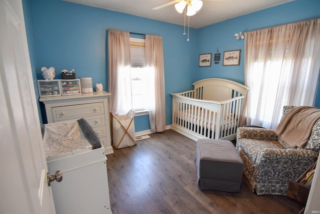2221 Washington Ave, Evansville, IN 47714 - bedroom featuring wood finished floors, a crib, and a ceiling fan