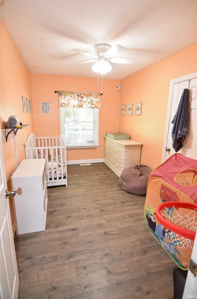 2221 Washington Ave, Evansville, IN 47714 - bedroom with dark wood-type flooring and ceiling fan