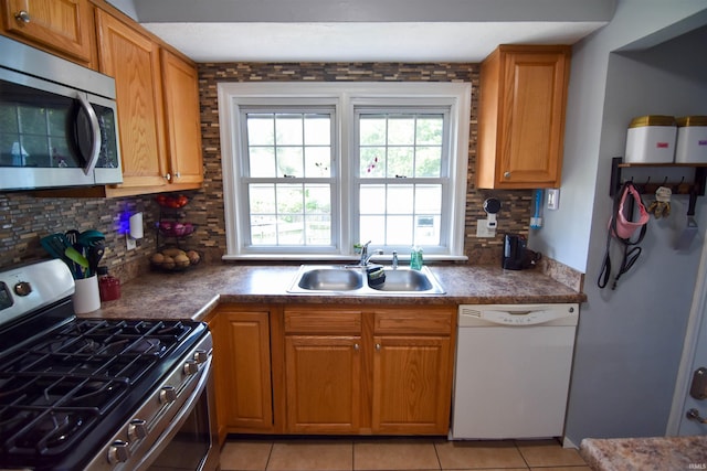 2221 Washington Ave, Evansville, IN 47714 - kitchen featuring appliances with stainless steel finishes, decorative backsplash, light tile patterned floors, and dark countertops