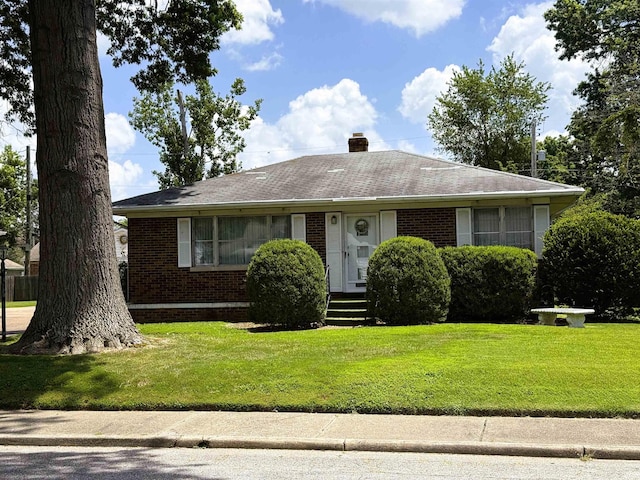 100 S Fairlawn Ave, Evansville, IN 47714 - view of front of house with brick siding, a front yard, a chimney, and roof with shingles
