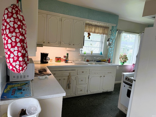 100 S Fairlawn Ave, Evansville, IN 47714 - kitchen featuring light countertops, white cabinetry, and stove