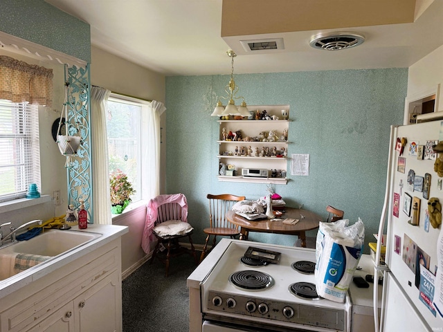 100 S Fairlawn Ave, Evansville, IN 47714 - kitchen with white appliances, light countertops, white cabinets, and pendant lighting
