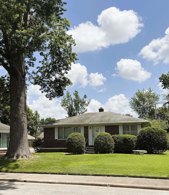 100 S Fairlawn Ave, Evansville, IN 47714 - view of front of home with a front lawn, brick siding, a chimney, and entry steps