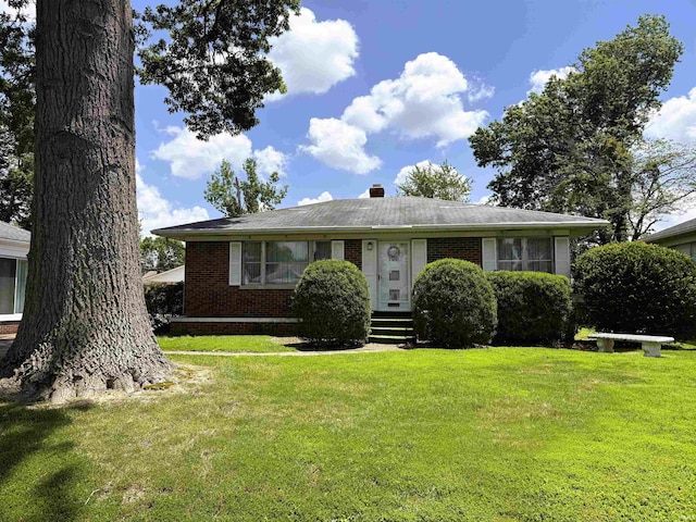 100 S Fairlawn Ave, Evansville, IN 47714 - view of front of home with brick siding, a front lawn, and a chimney