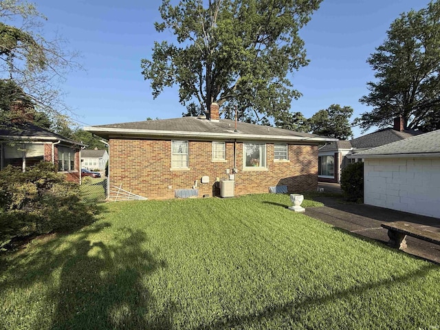 100 S Fairlawn Ave, Evansville, IN 47714 - rear view of property with brick siding, a lawn, and a chimney