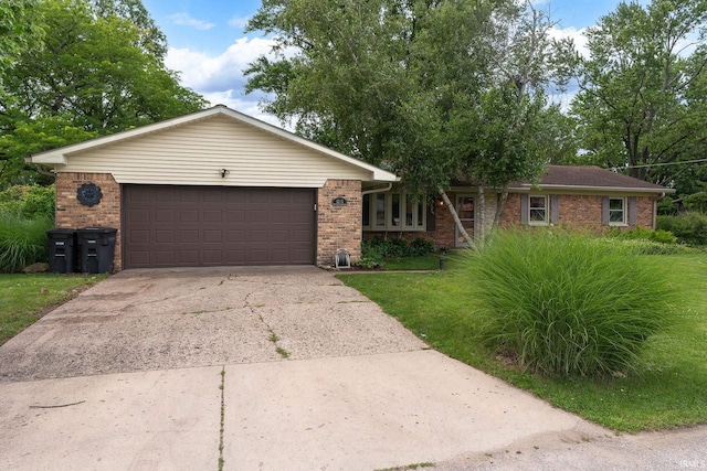 1205 Norma Jean Dr, Lafayette, IN 47909 - ranch-style home with brick siding, concrete driveway, an attached garage, and a front lawn